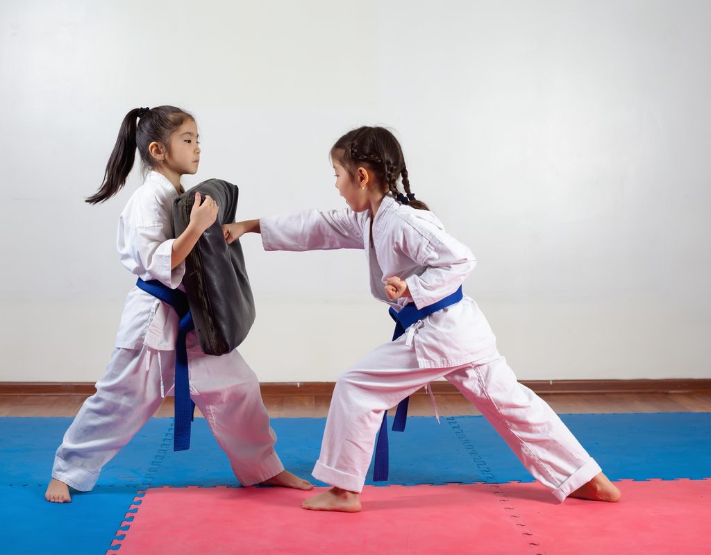 Two girls practicing karate