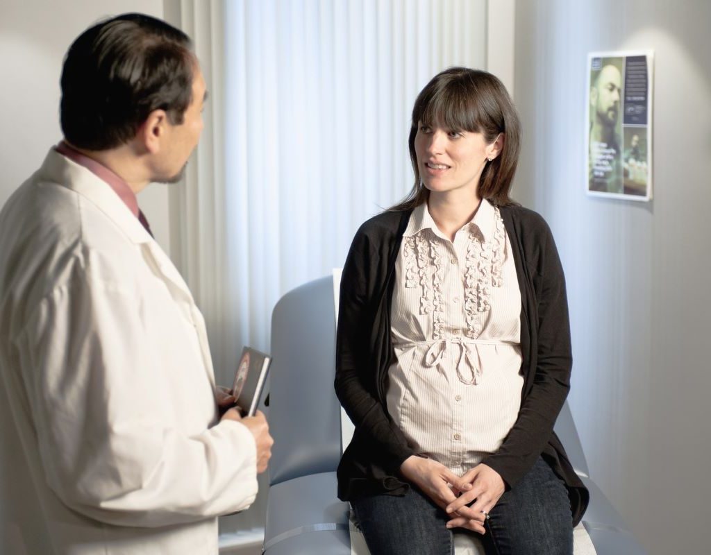 Obstetrician talking to his patient