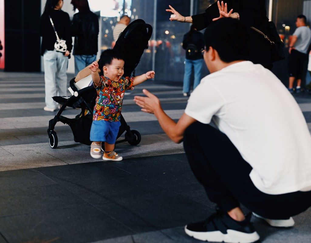 Father playing with toddler at an airport