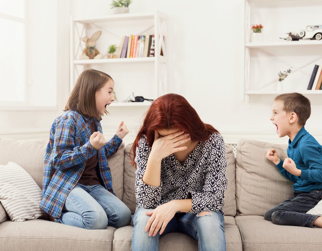 mom frustrated with two kids fighting