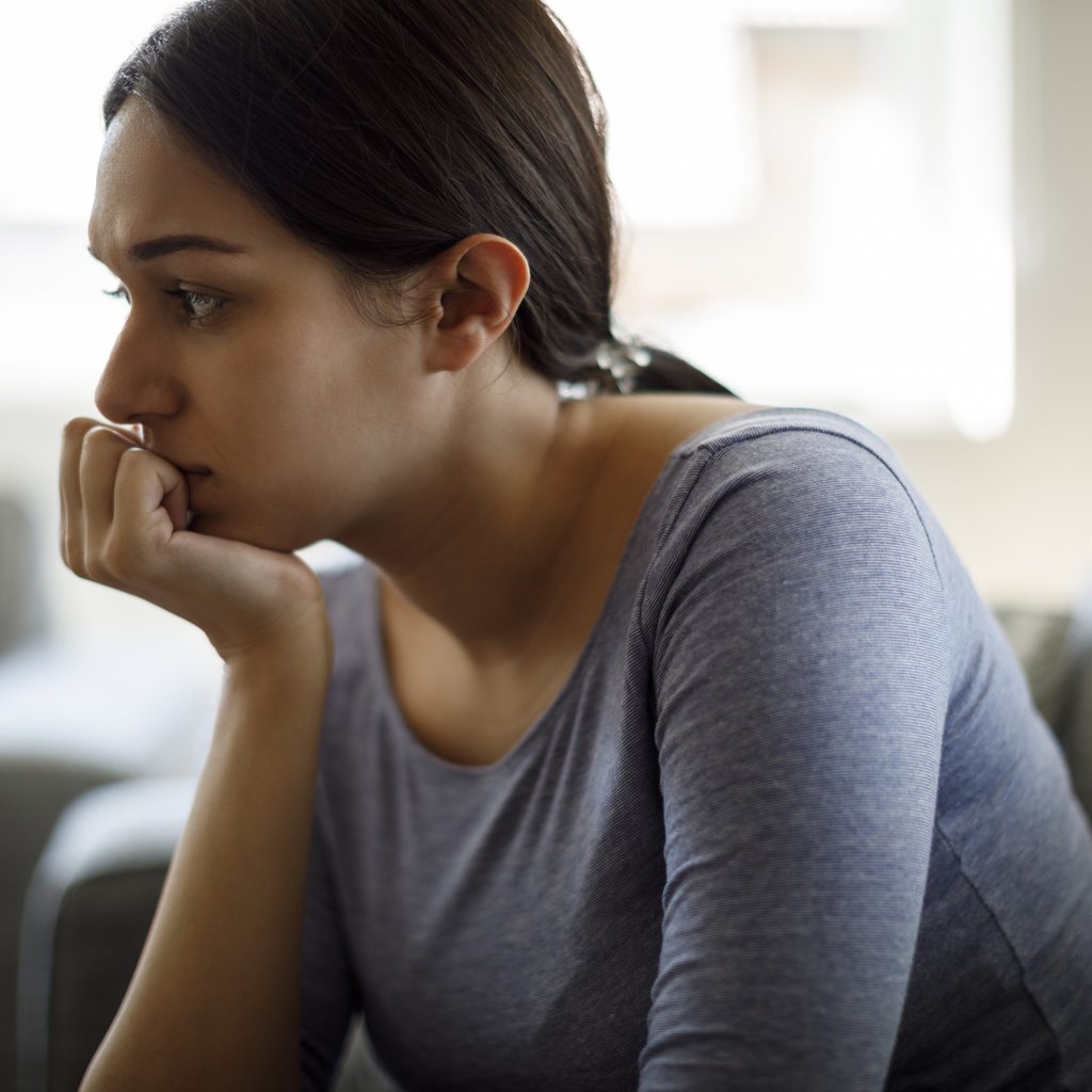 worried-woman-sitting-couch