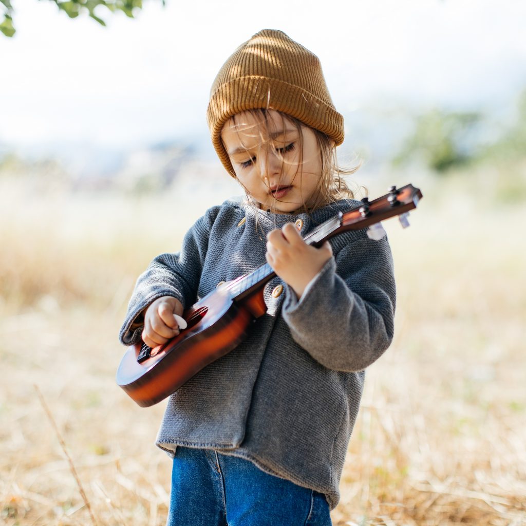Toddler playing guitar