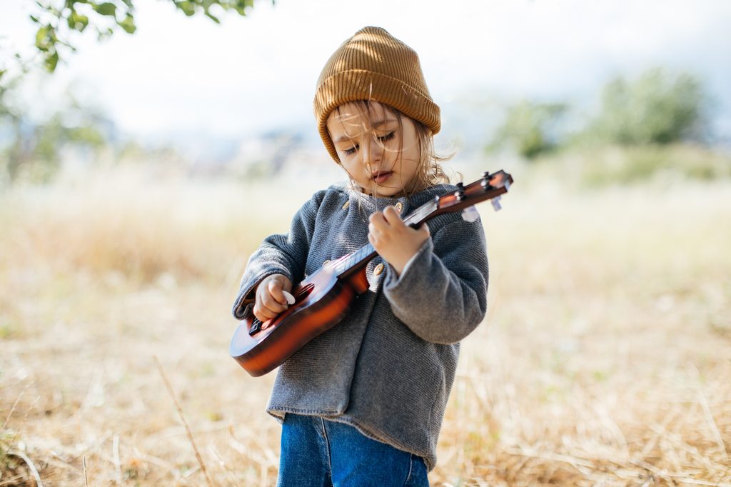 Toddler playing guitar