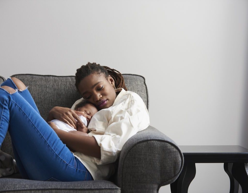 new-mother-cuddling-infant