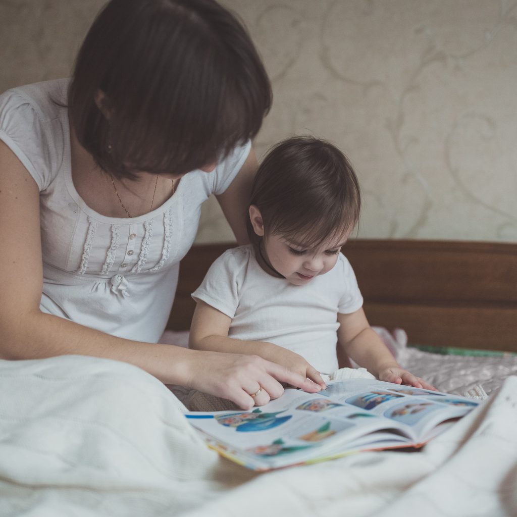reading to toddler in bed