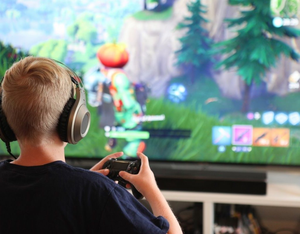 blond child playing fortnite