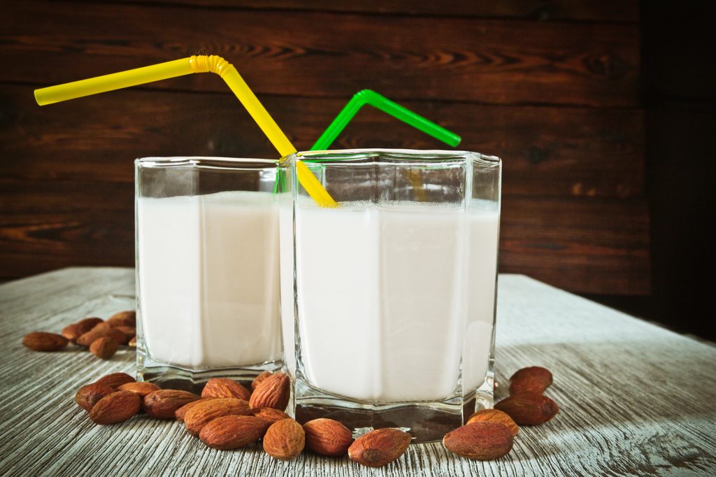 two glasses of almond milk with straws