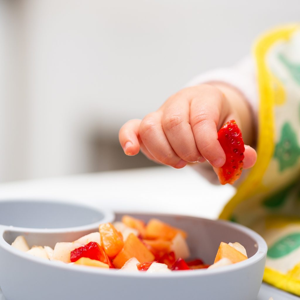 baby eating fruit