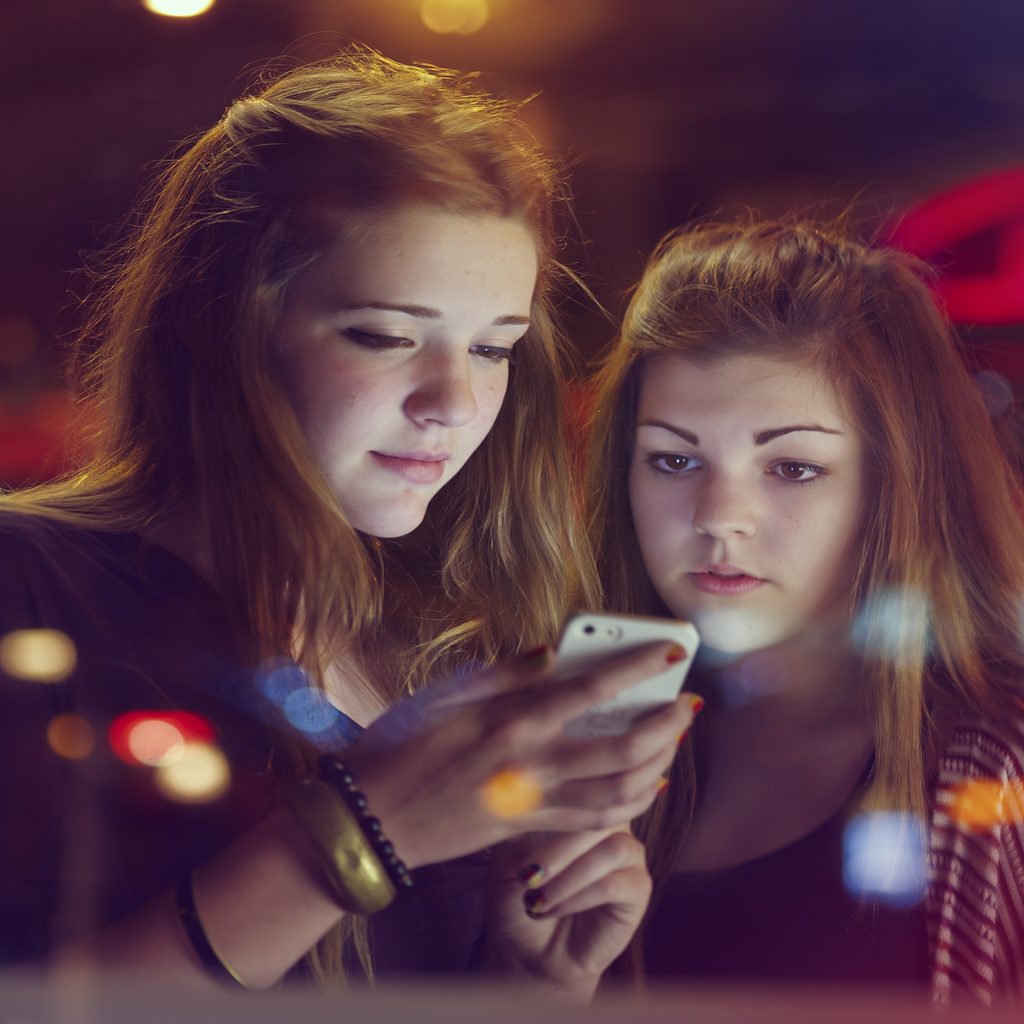 teen-girls-looking-at-phones-and-tiktok