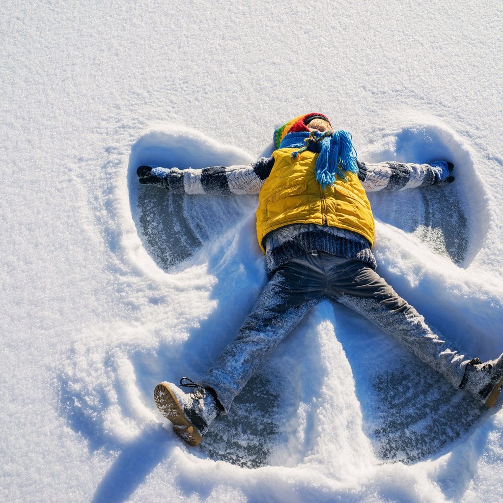 Boy making a snow angel