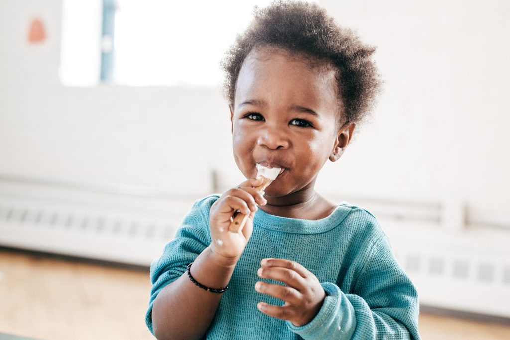 toddler-enjoying-yummy-breakfast-smoothie-bowl