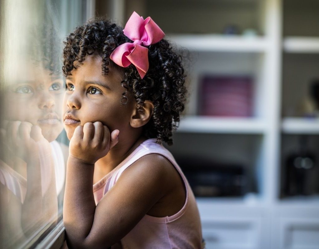 preschool girl dreaming looking out window
