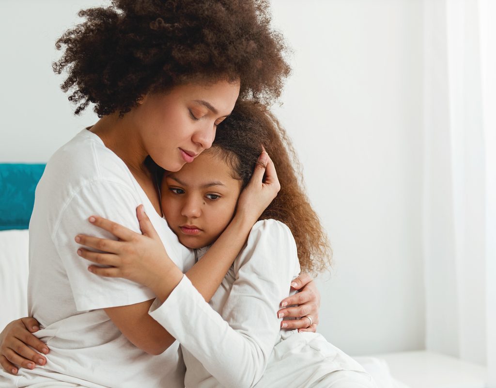 Mom comforting her daughter with words of encouragement
