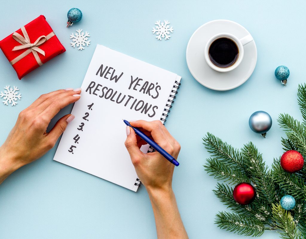 A person making a list of New Year's resolutions for the family