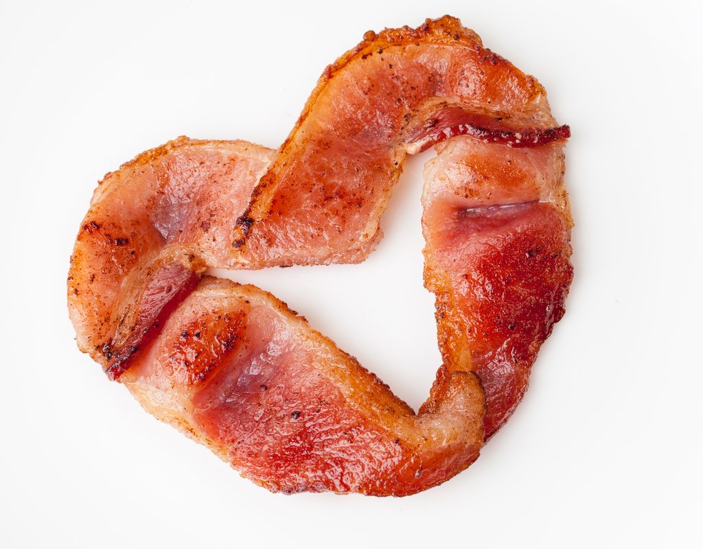slice of bacon shaped in a heart