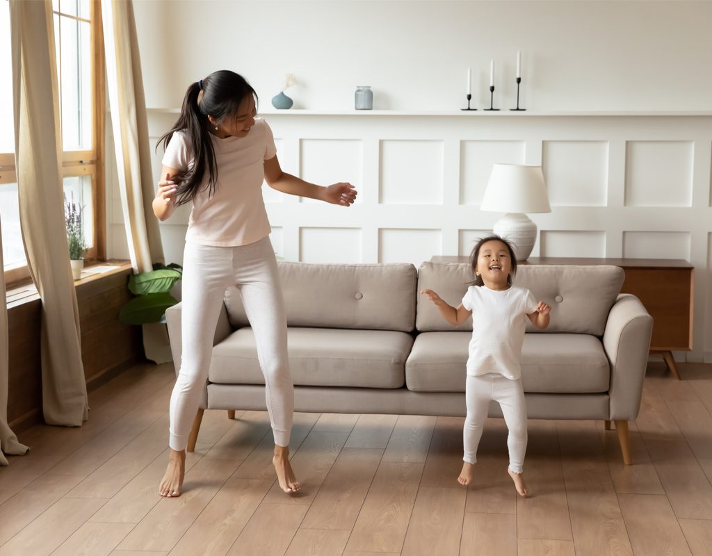 mom and toddler girl having fun with music and movement activity