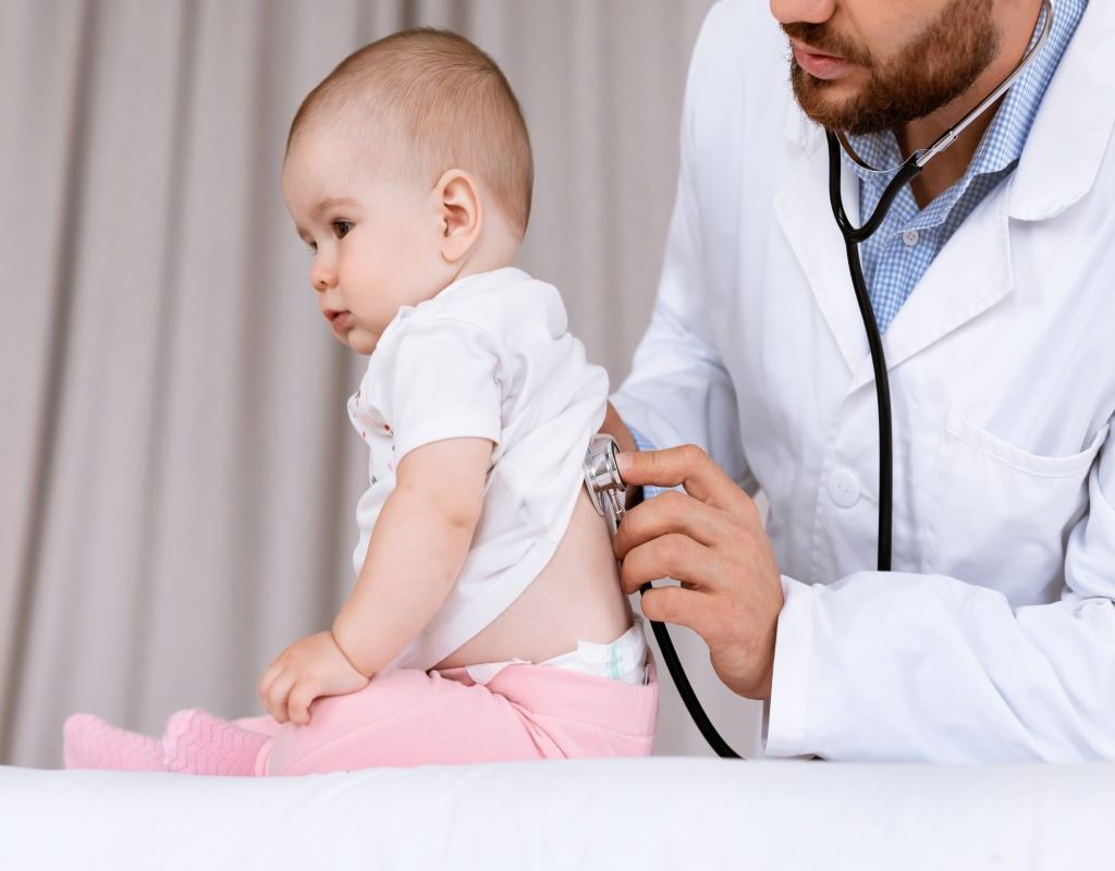 Doctor listens to baby's breathing with stethoscope