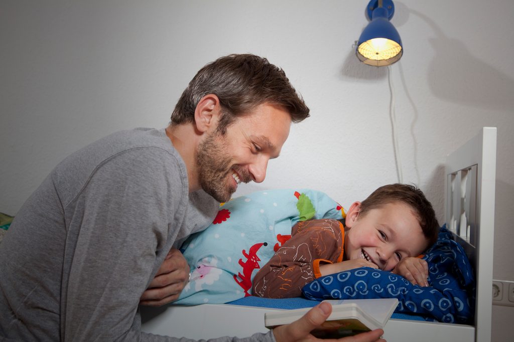 Dad reading to child.