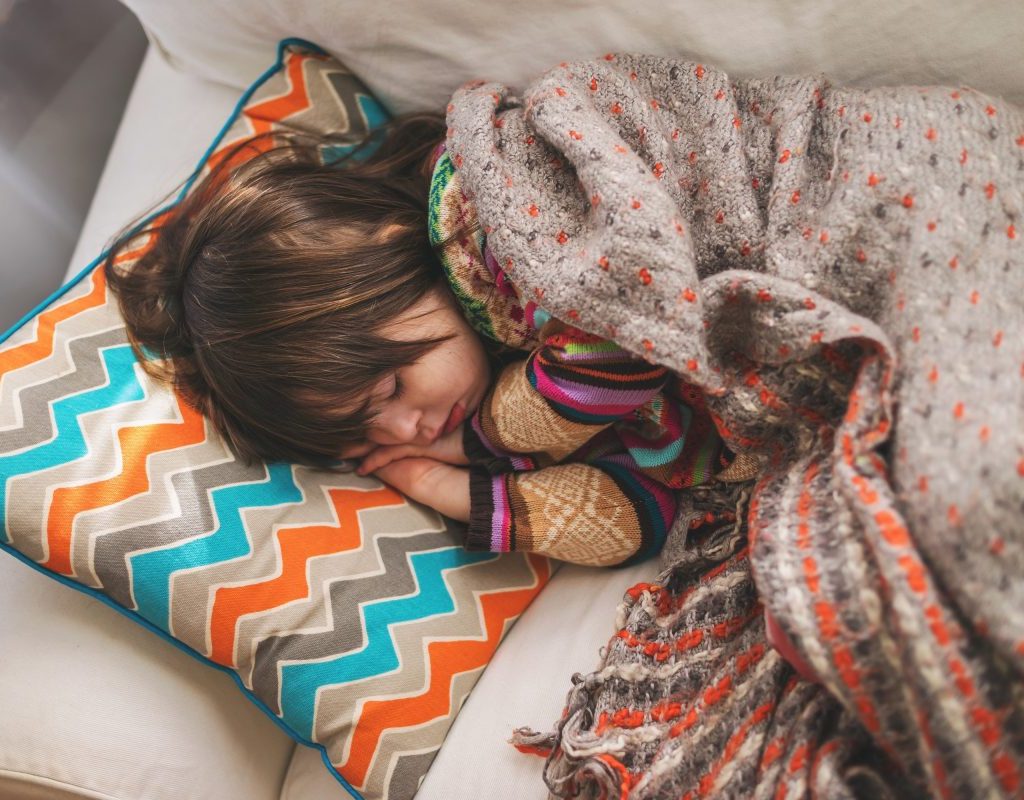 Sick toddler sleeping on sofa