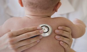 Doctor listening to baby's lungs