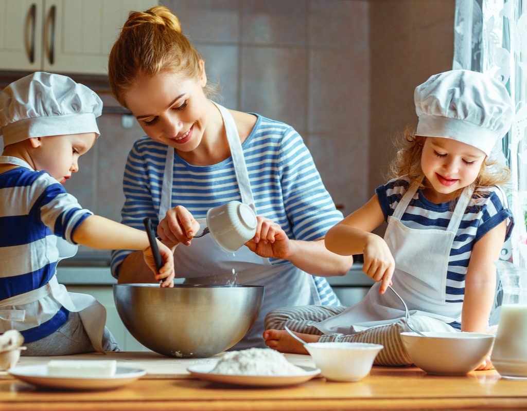 Mom and kids cooking together