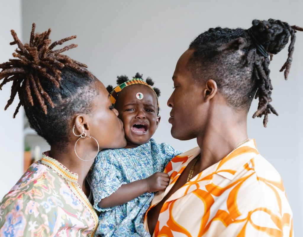 Parents comfort crying little girl
