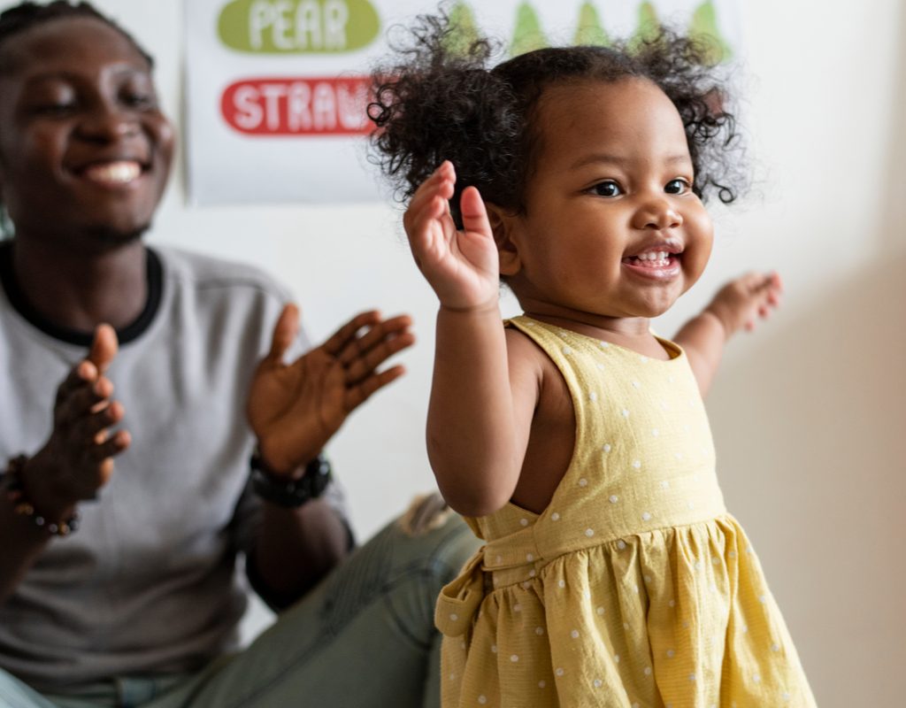 happy toddler girl playing party games