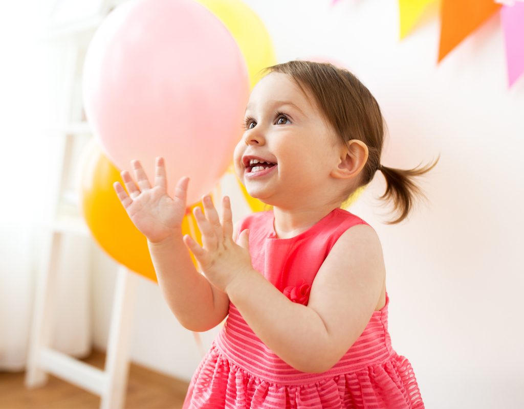 Happy toddler playing party games