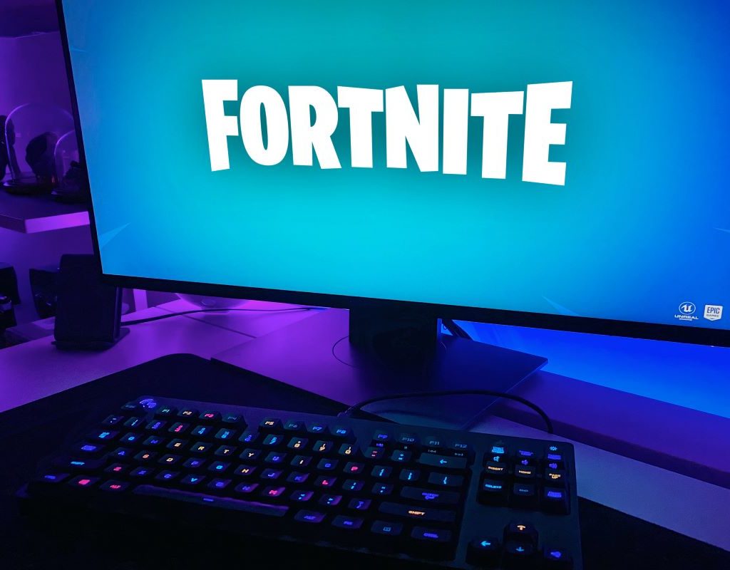 A computer monitor displaying the FortNite logo