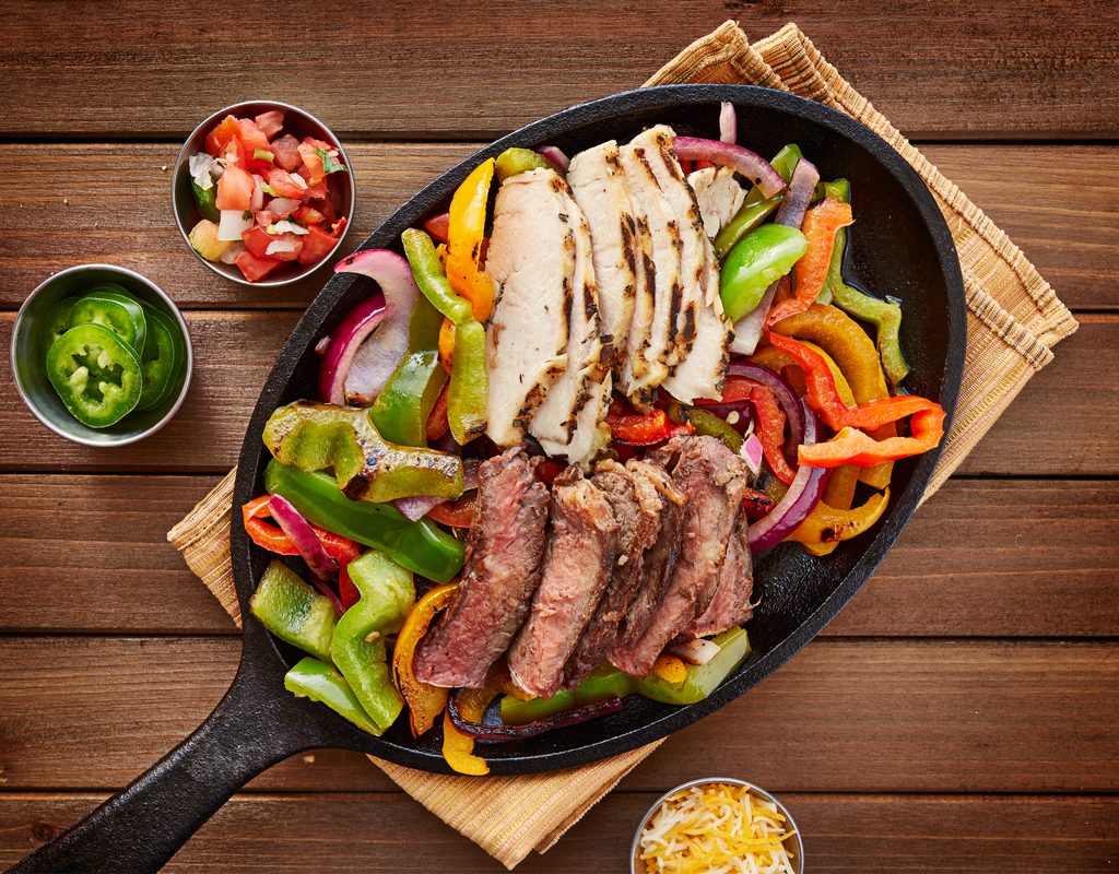 pan of chicken and steak fajitas ready to serve