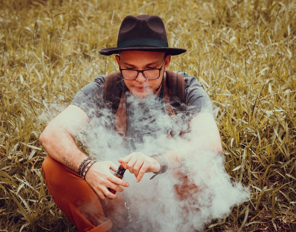 Teen sitting and vaping