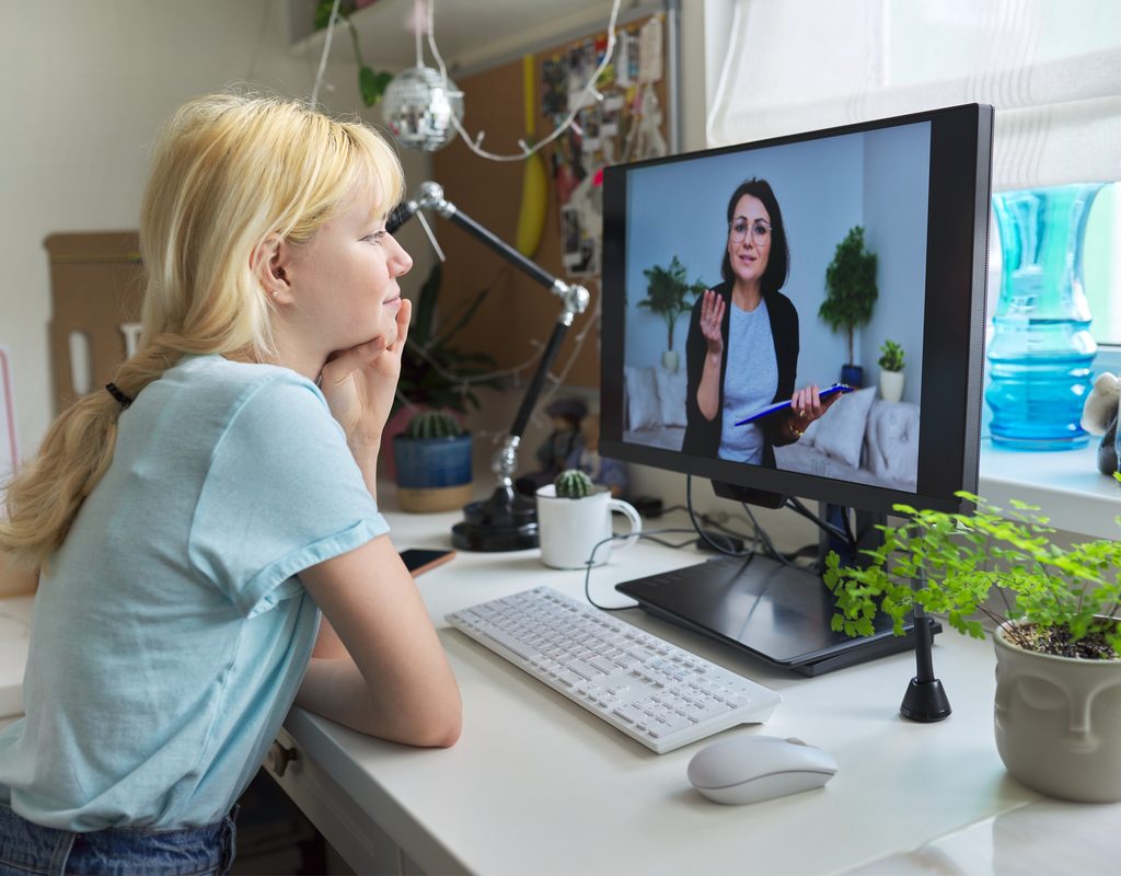 teen girl doing an online therapy session at home
