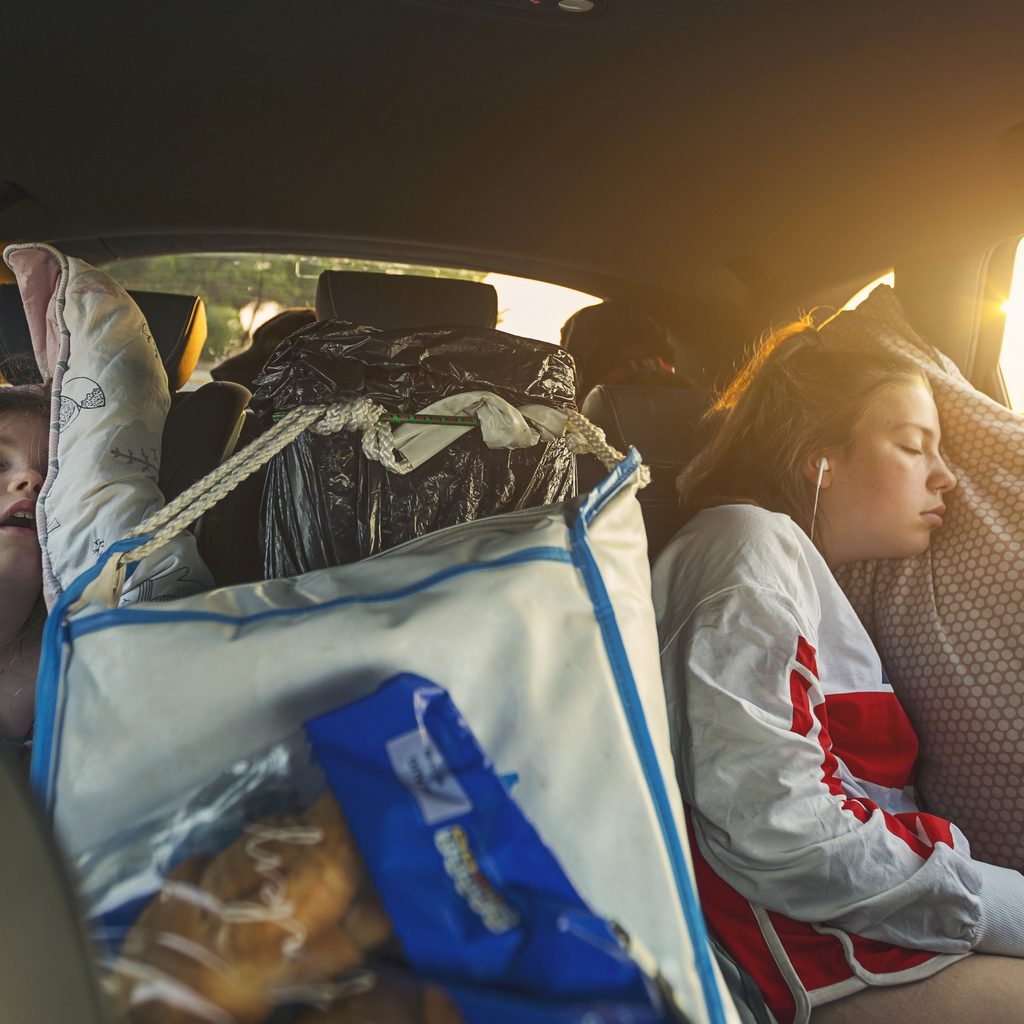 Kids sleeping in back seat of a car