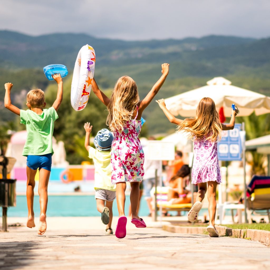 Kids running to enjoy a resort vacation