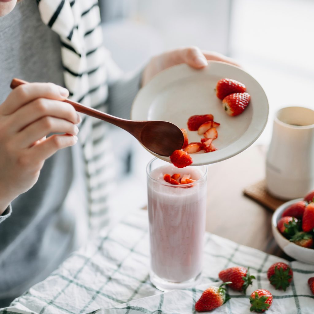 Parent preparing smoothie for breakfast