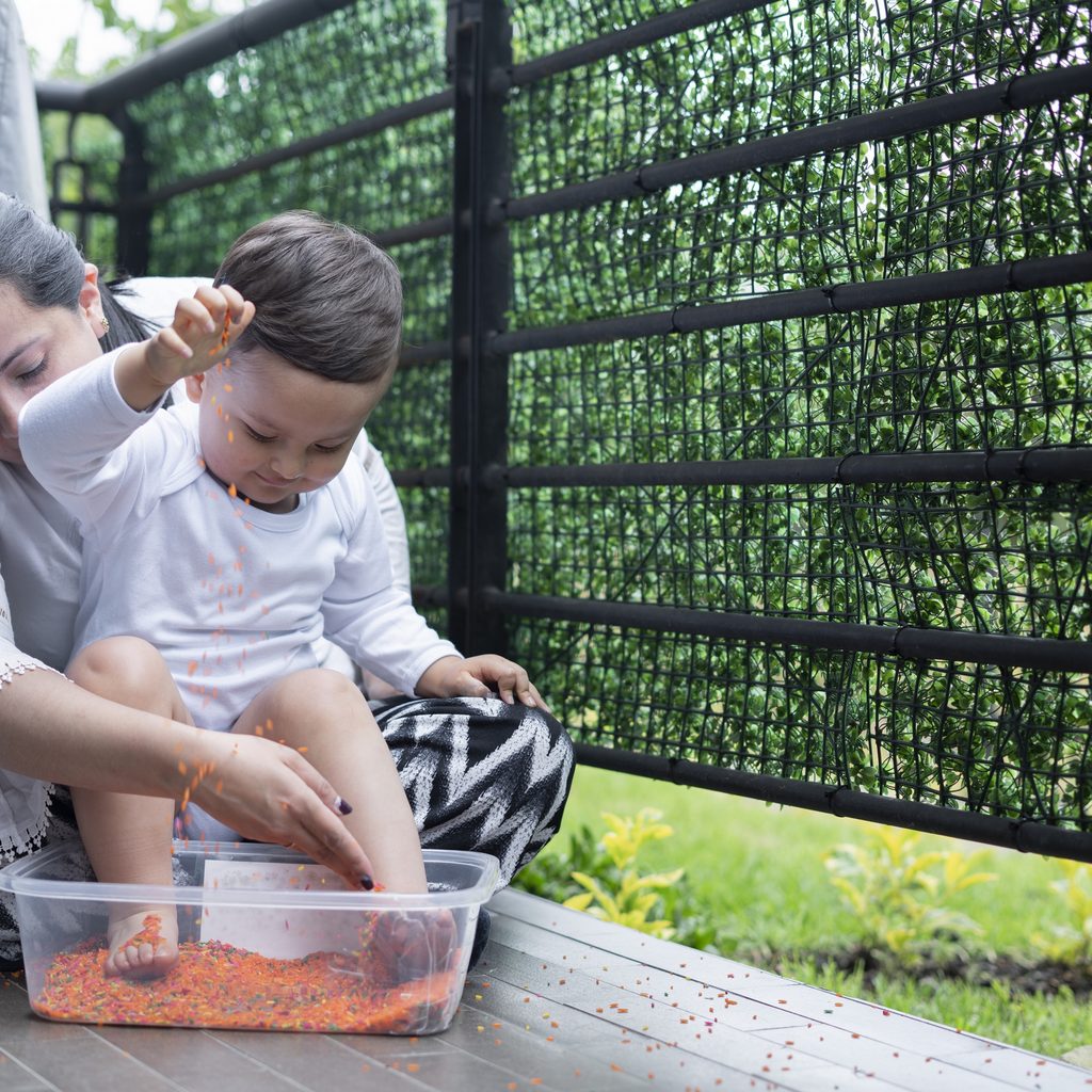 Mother and child playing with sensory bin
