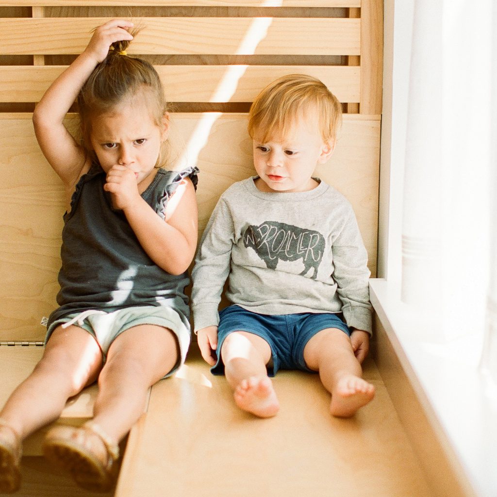Toddler pulling her hair and sucking her thumb.