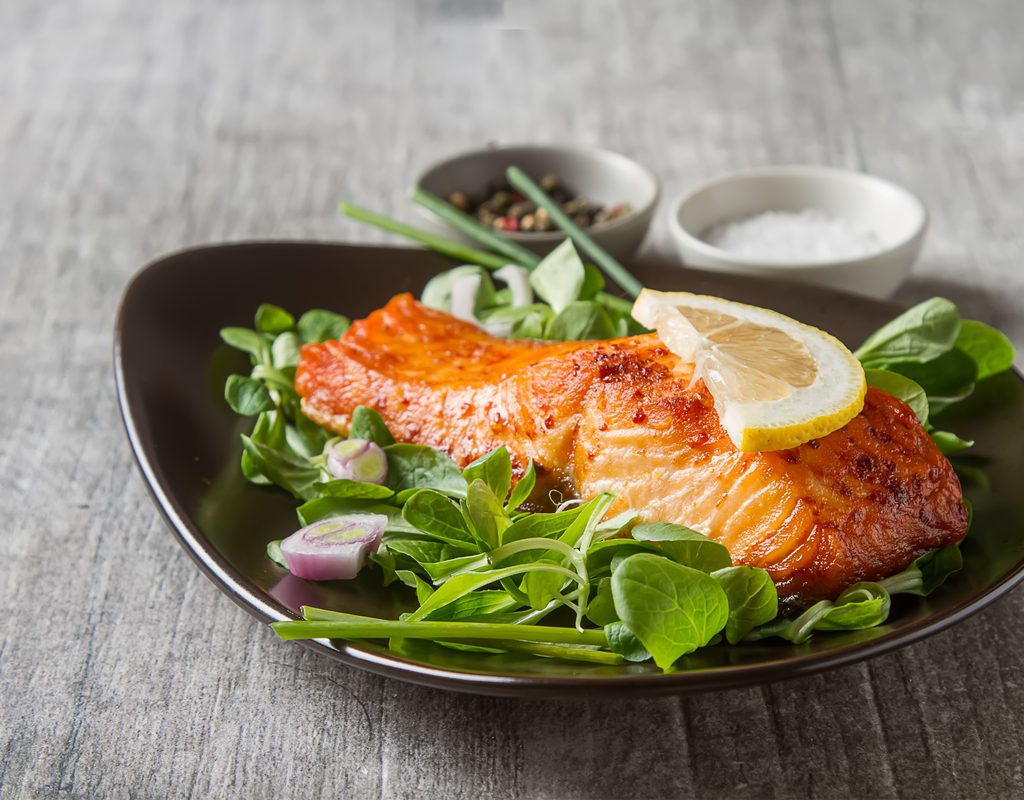 Lemon garlic salmon dish on a plate with spinach