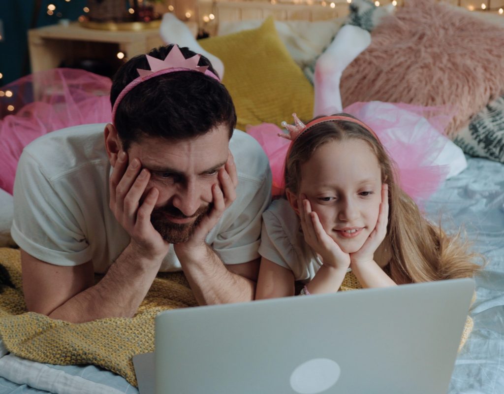 A father and daughter watching a movie dressed up