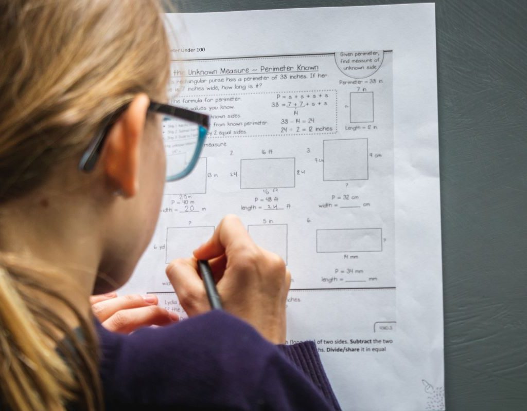 Student working on a math worksheet on the board