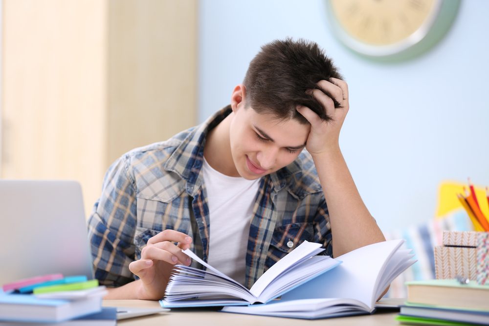 Teen studying from a book
