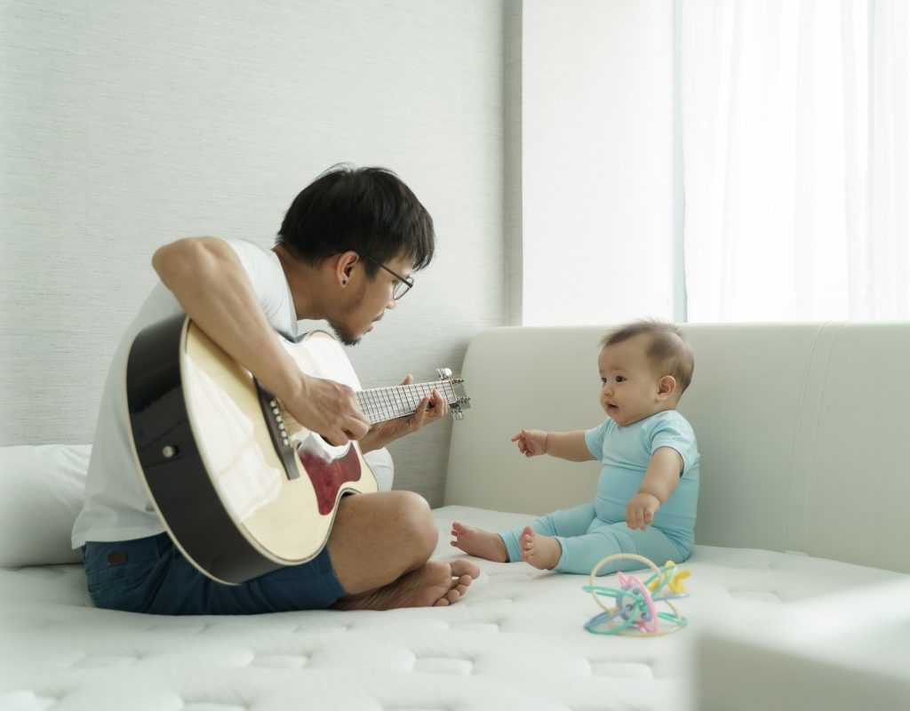 A father singing a song to his baby.
