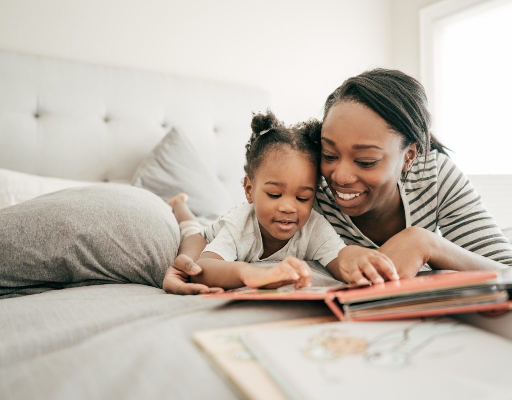 A mother reading her young child a bedtime story