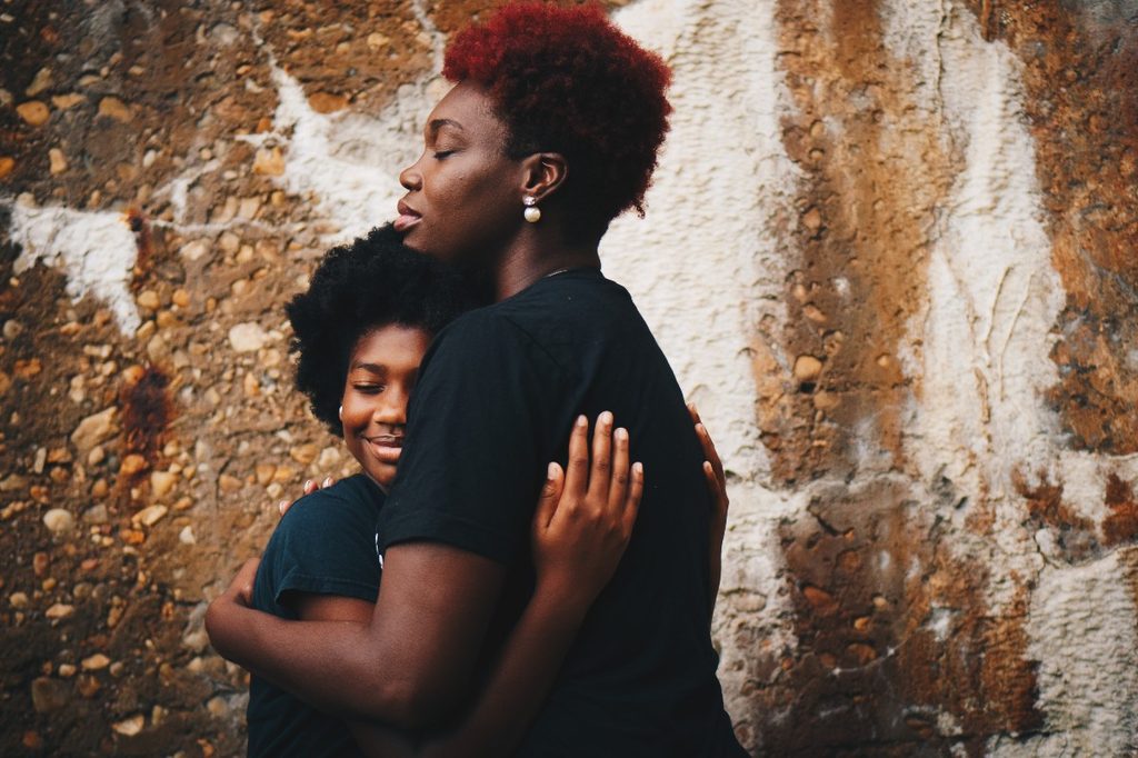 an adult hugging a child