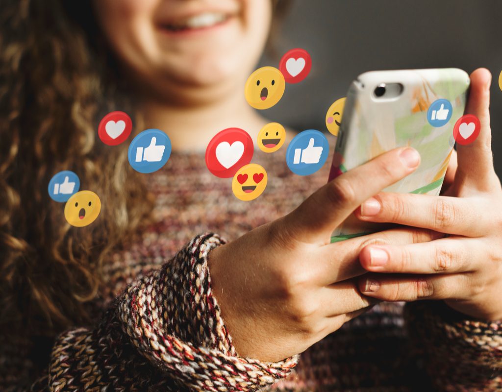 A teen using social media on her cell phone.