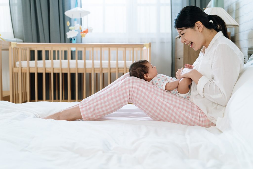 A mother singing to her little baby.