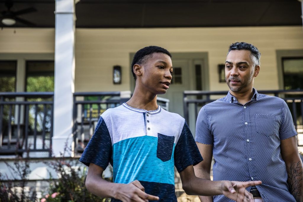 A father and son walking and having a conversation