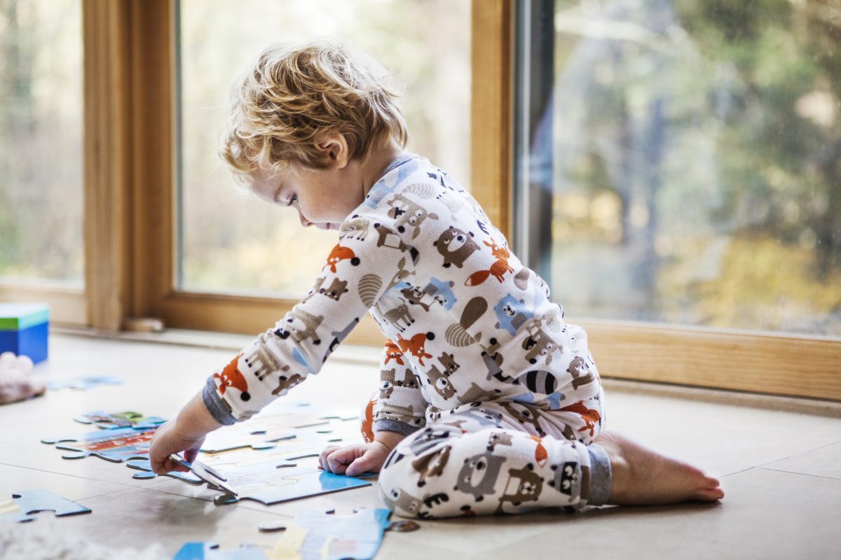 A toddler putting together a puzzle.