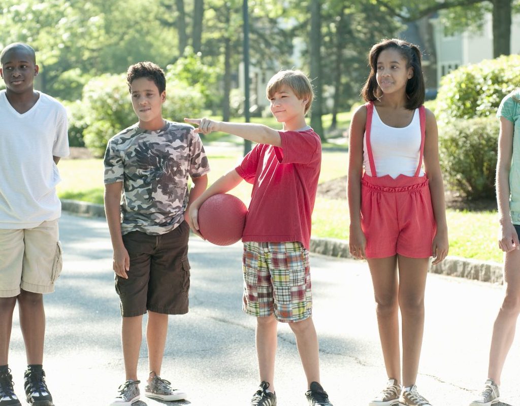 A group of kids picking kickball teams.