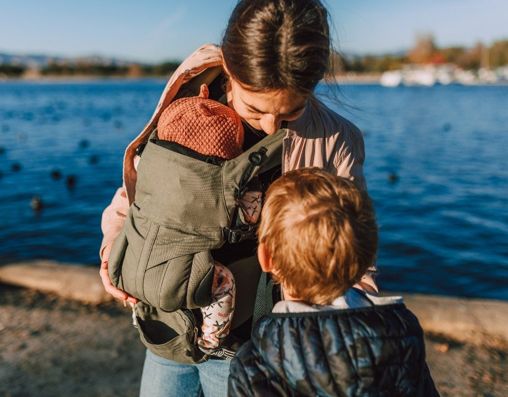 Mother and children by water